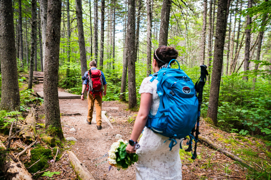 hiking elopement, bride hiking with backpack Vermont Wedding Photographer Andy Madea