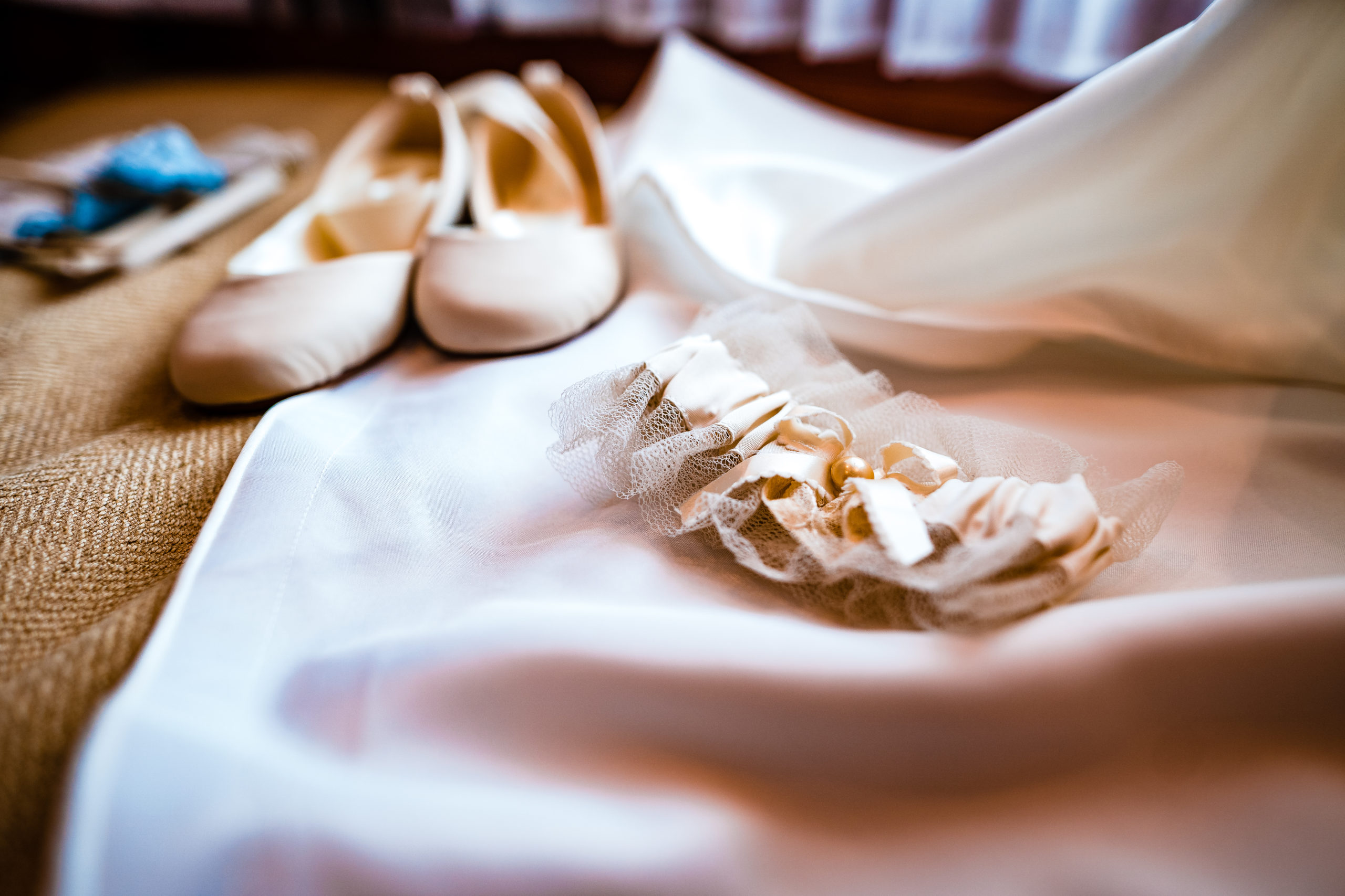 Wedding shoes and heirloom garter by vermont wedding photographer andy madea
